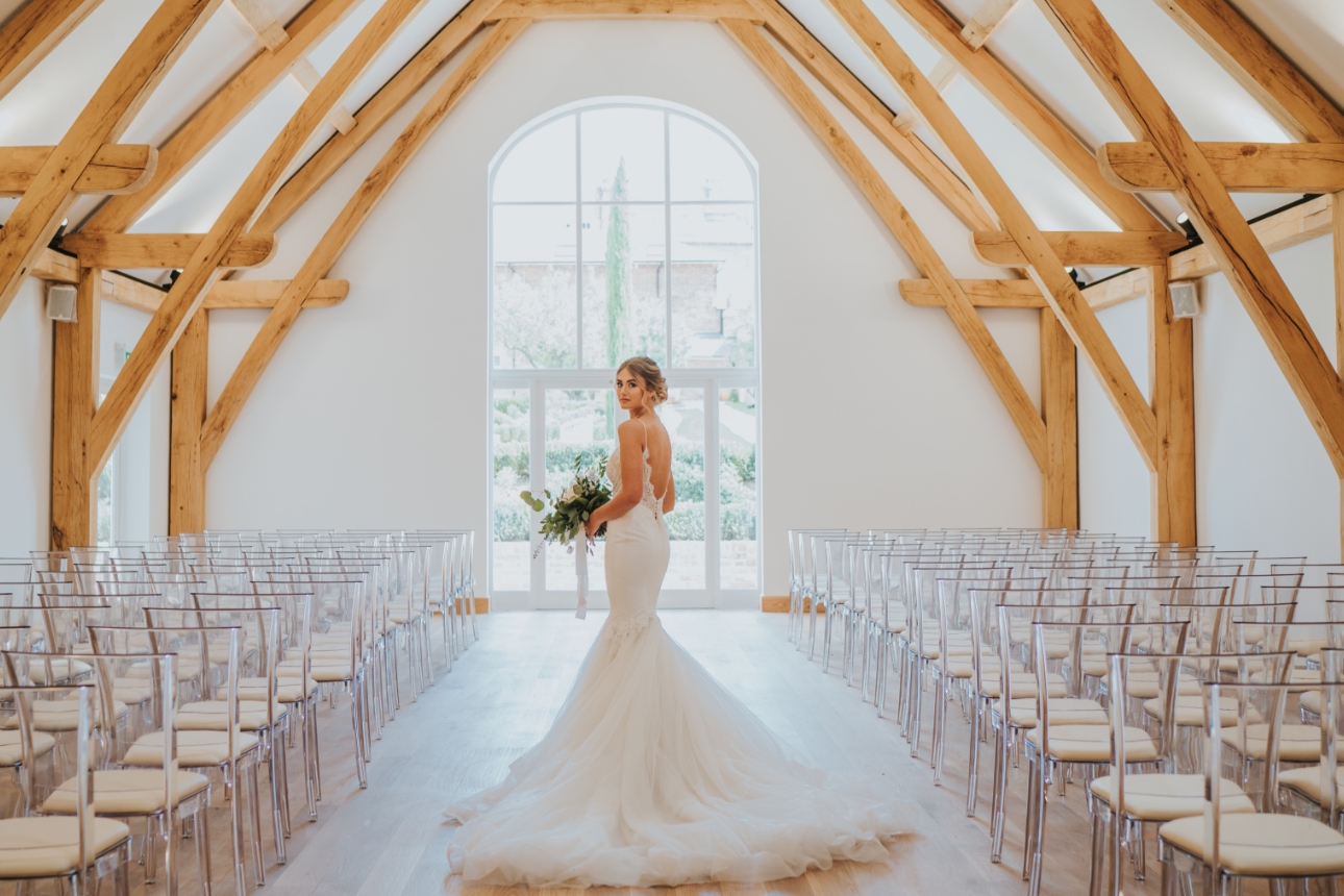 Bride in white, oak framed room with high ceilings at Hatfield Place