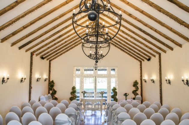 Large oak framed barn at Crondon Park dressed with purple and while balloons