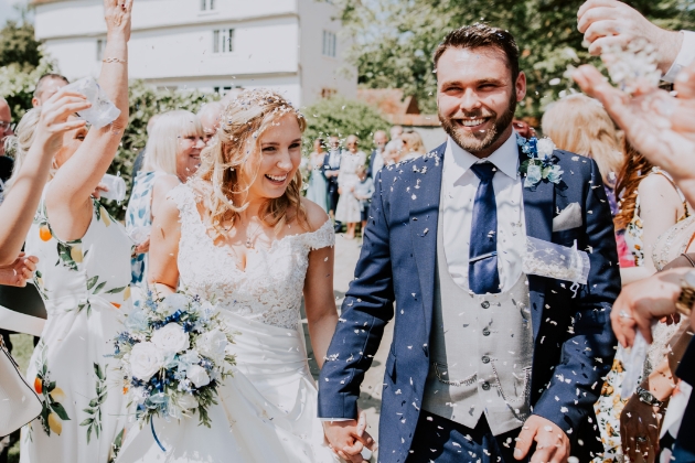 Real bride Larissa walks through confetti guard of honour