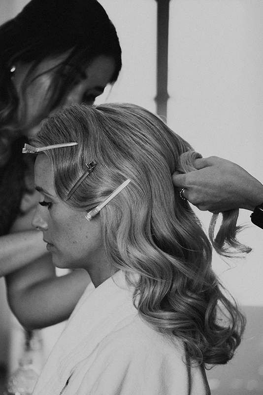 Sally-Kate Duboux styling a bride's hair for a wedding