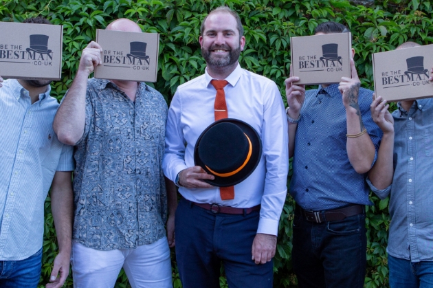 Jonnie Dowding clutches top hat with four groomsmen