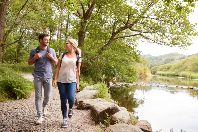 Couple walk alongside a lake