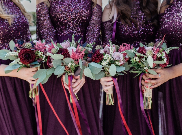 Bridesmaids wear aubergine-coloured maxi dresses