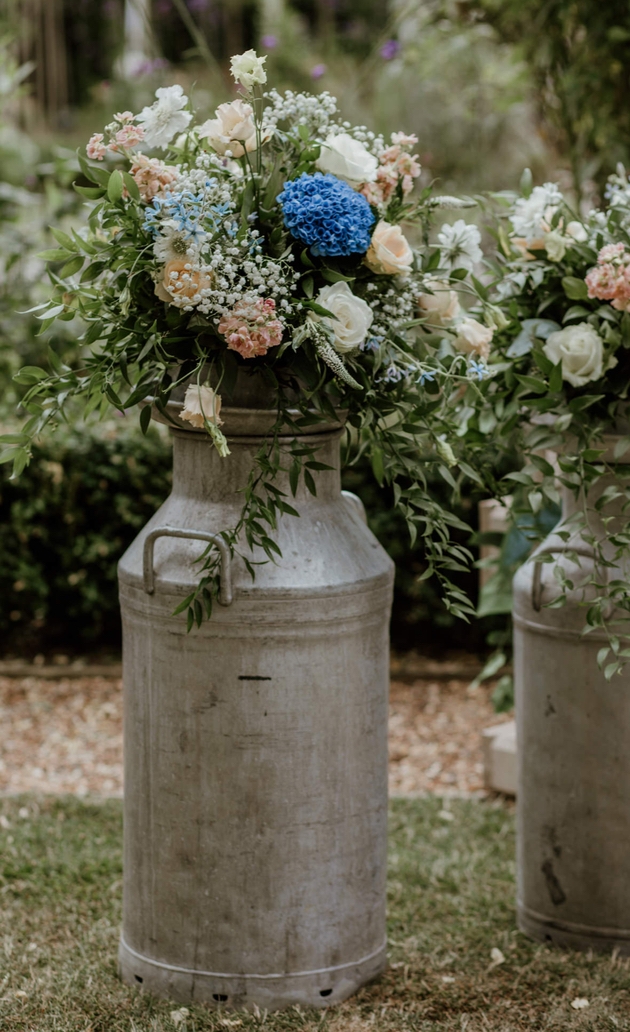 Pink and blue flower arrangement in metal urn by Essex florist Alison White Wedding Flowers 
