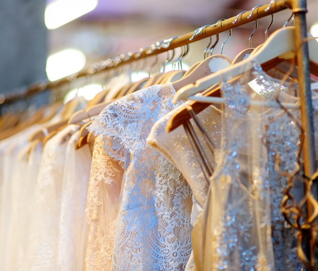 Wedding dresses hanging on rail