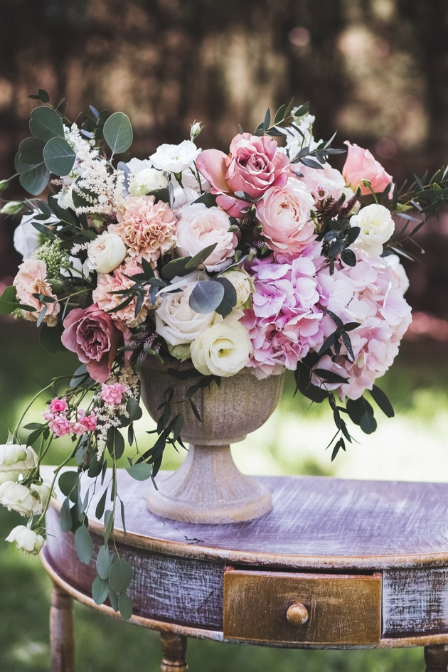 Pink roses and flowers in urn for wedding