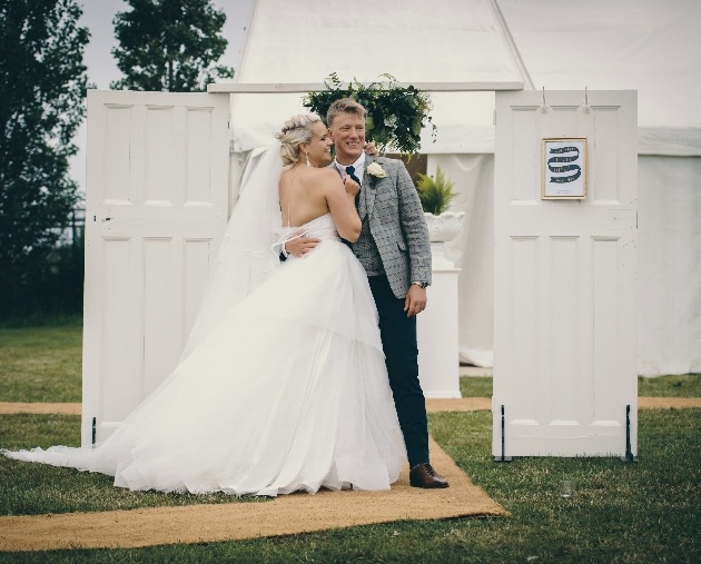 Couple pose with outdoor venue props