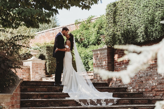 Bride and groom on the lawns in front of Braxted Park