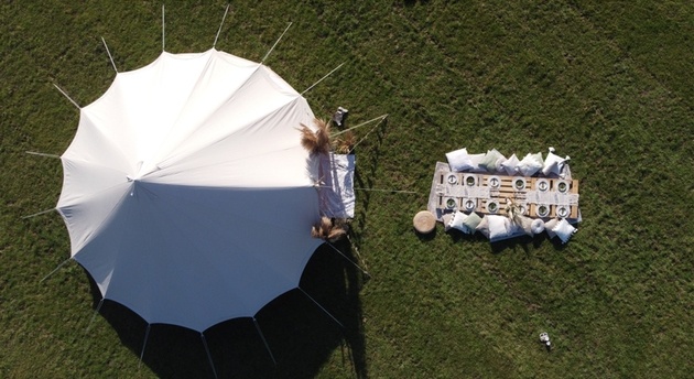 Overhead shot of bell tent set up for a boho wedding.