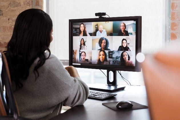 business woman attending a virtual meeting with colleagues