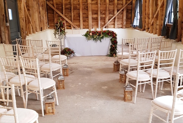 Interior of barn wedding venue Richwill Farm with flowers