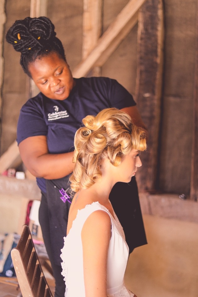 Make-up artist Rue Garande of Shades of Beauty Essex styling a bride's hair