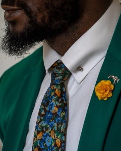 man in green suit and floral tie