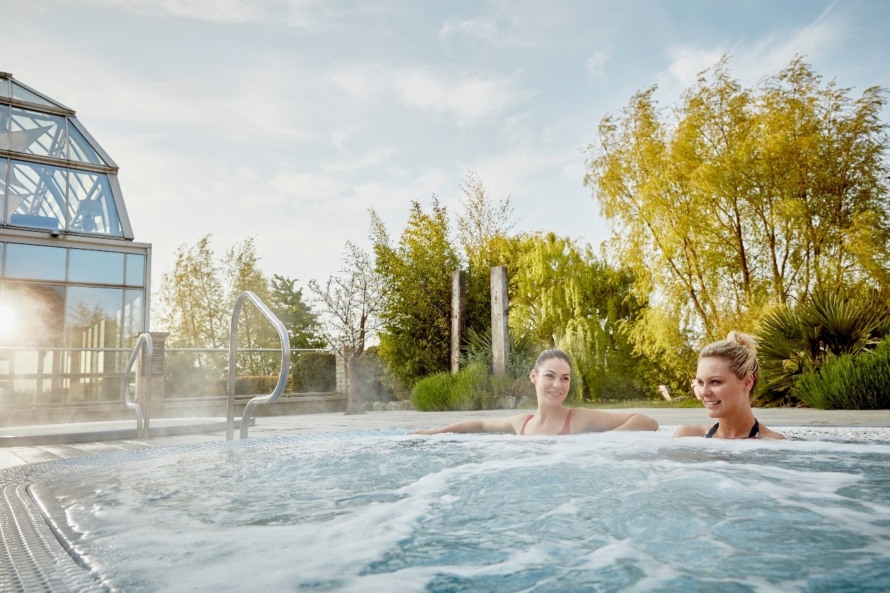 two people in a hot tub outdoors