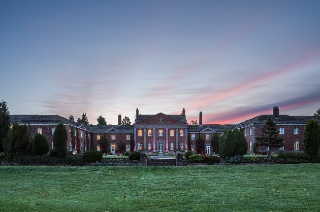 historic red and white column house at night 