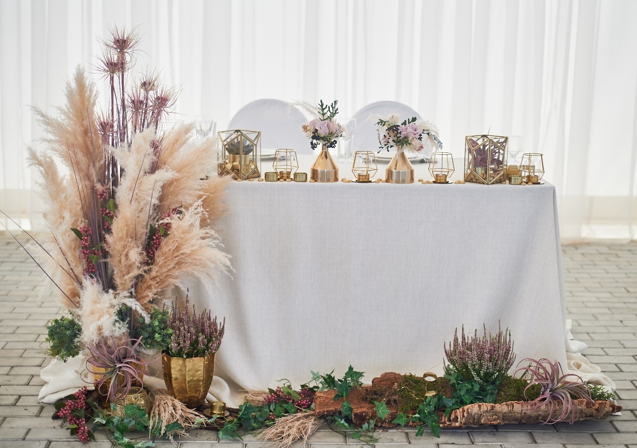 top table set up with pampas grass and succulents and gold decor