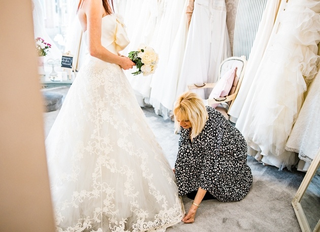 Sharyn Warner of Bridal Reloved Maldon in Essex helps a bride find her wedding dress.