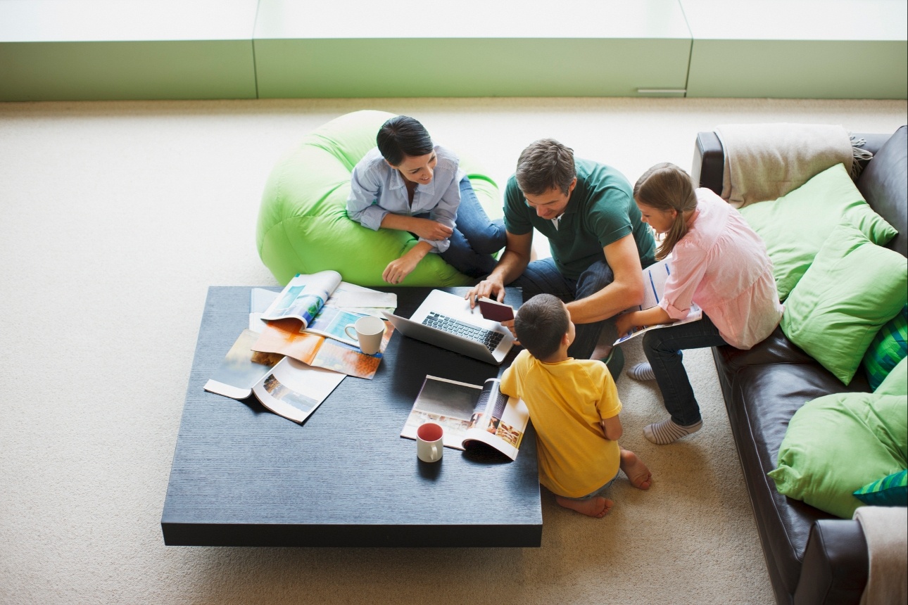 couple and their children on sofa in lounge