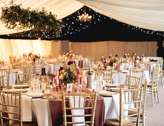 Barn interior dressed for wedding with flowers and candles