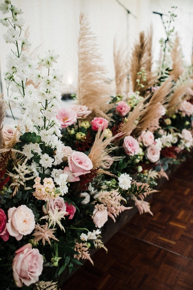 large floral blooms in planter on the floor