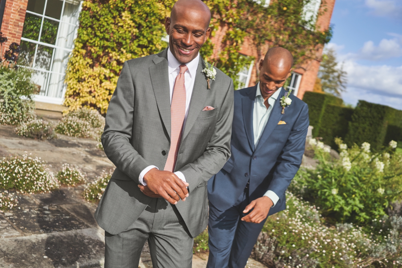 two models in suits by country house