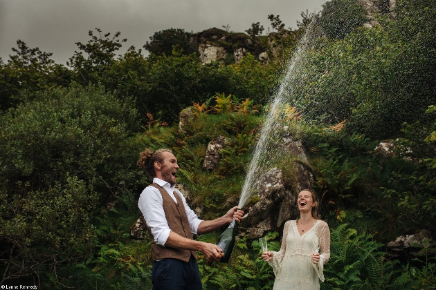 couple outdoors with a magnum of champagne