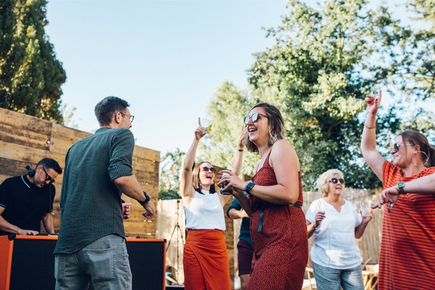 Wedding guests dancing to a DJ.