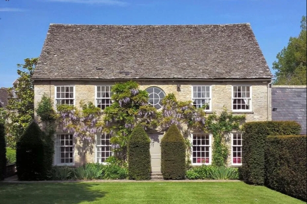 wisteria clad stone cottage lawn