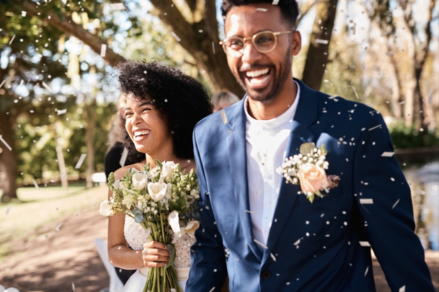 Newlywed couple on their wedding day with confetti