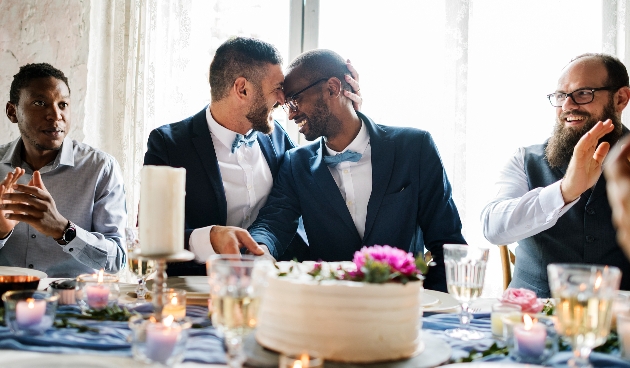 wedding couple at table at reception with food and drink