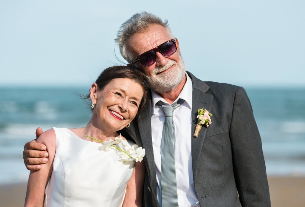 couple in wedding attire on beach