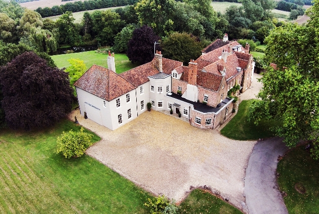 historic venue with cream facade and red slate roof with ample grounds