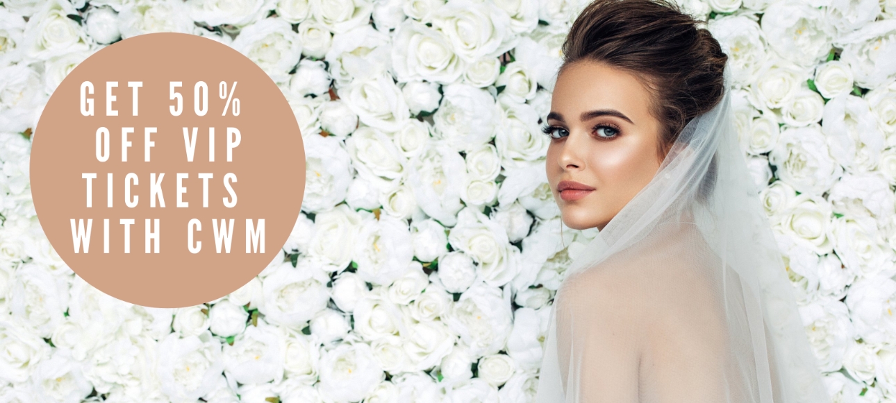 beautiful bride wearing a veil background of white flower wall