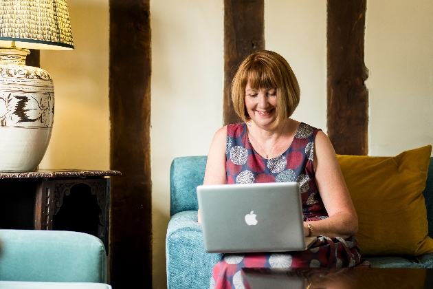 lady sitting on the sofa with her laptop