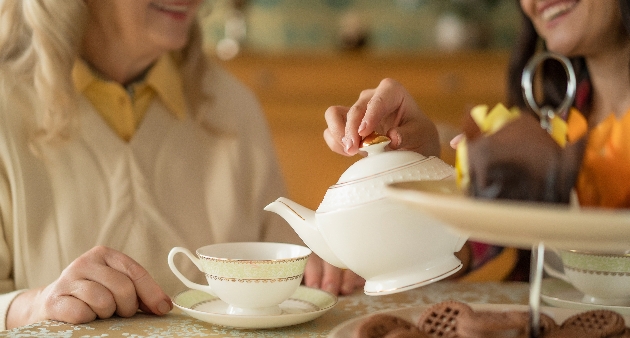 two women pouring tea in to cups