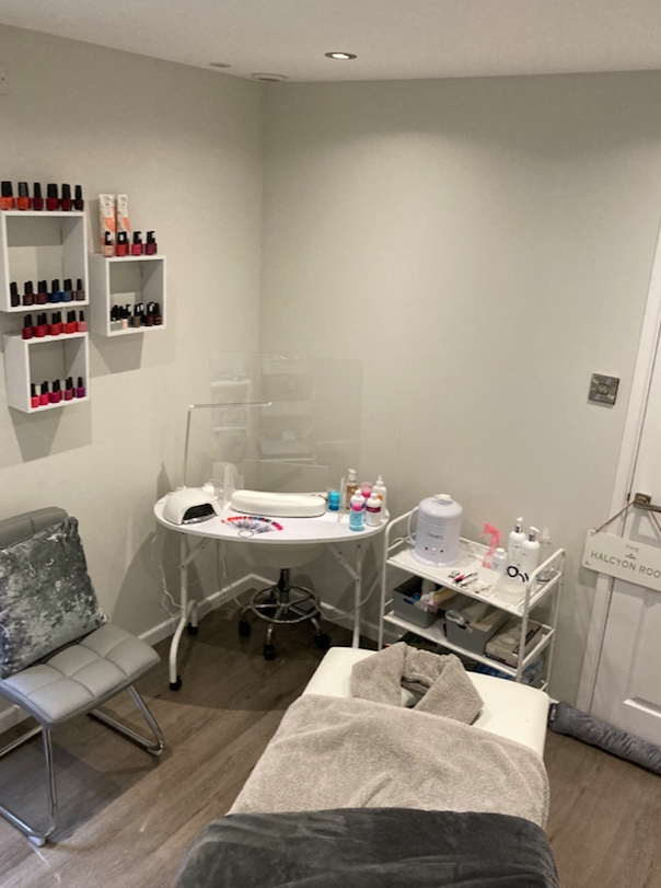 at home salon with bed and table with nail varnish on the shelves