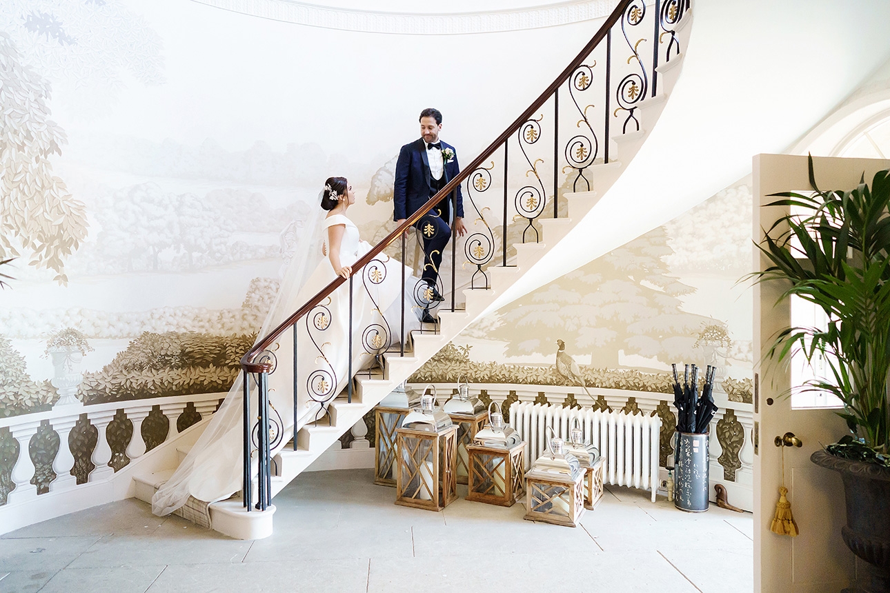 Newlyweds walk up staircase