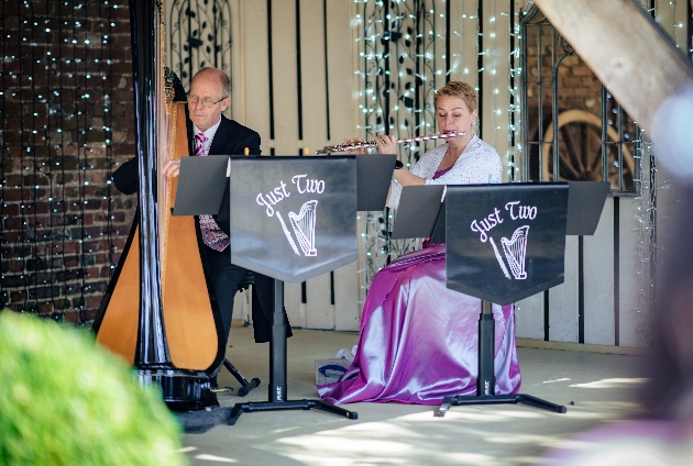 flute and harp duo performing outside 