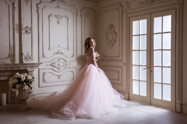 bride in an large princess style gown in a manor house