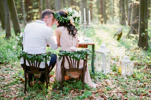 bride and groom sat on chairs outside