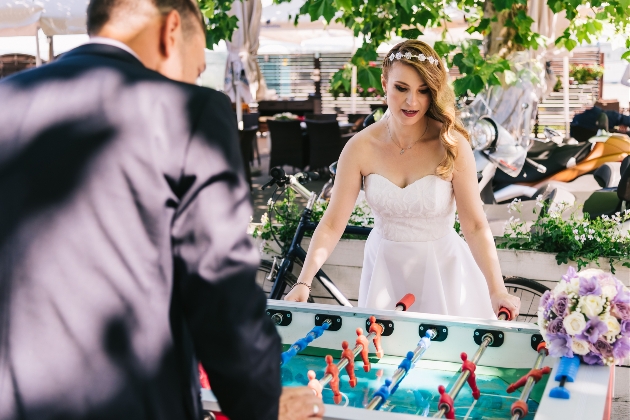 bride and groom playing table football