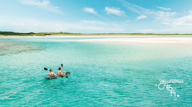 couple kayak in crystal blue sea in the bahamas