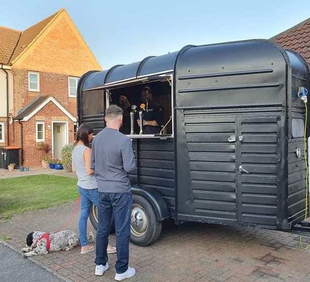 Mobile bar horse box black parked outside residential home