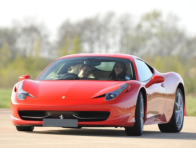 woman and driver in a red ferrari 