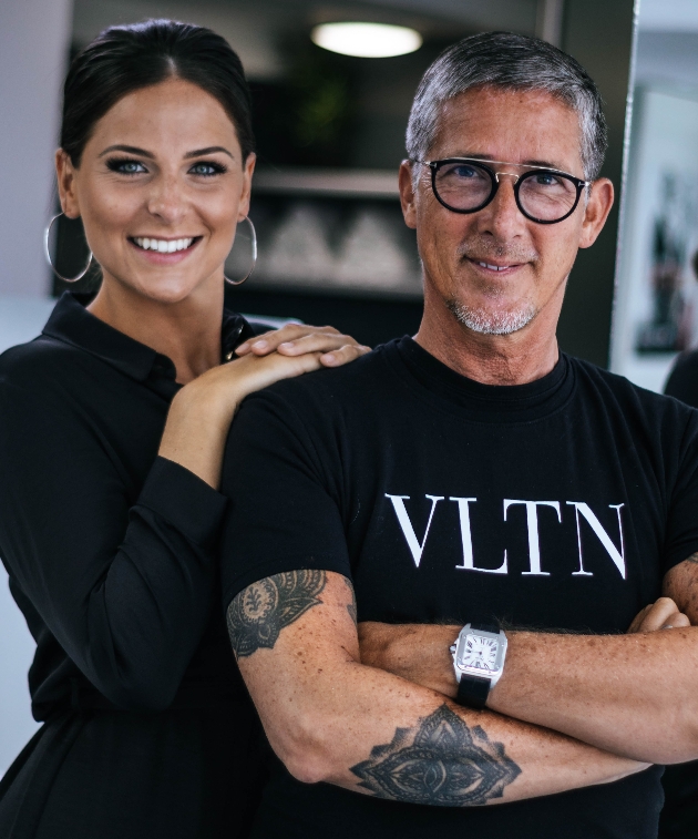 man and woman both wearing black standing together