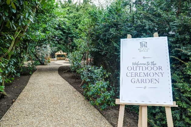 sign guiding people to outdoor ceremony area