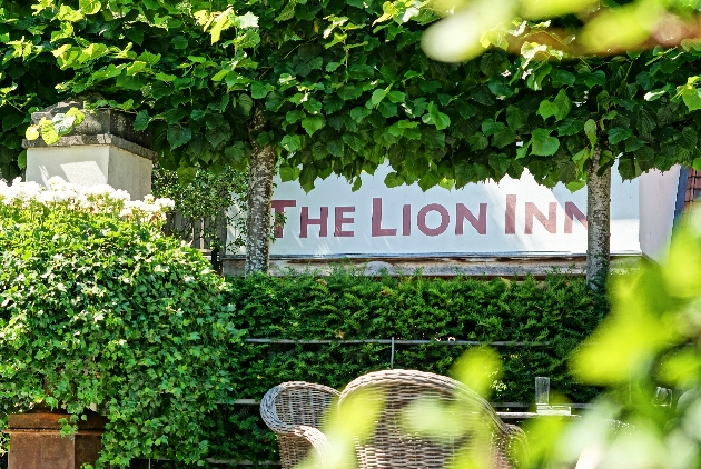 The Lion Inn sign in bushes