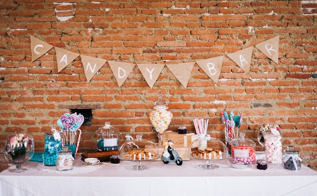 candy bar at a wedding filled with lots of jars with sweets
