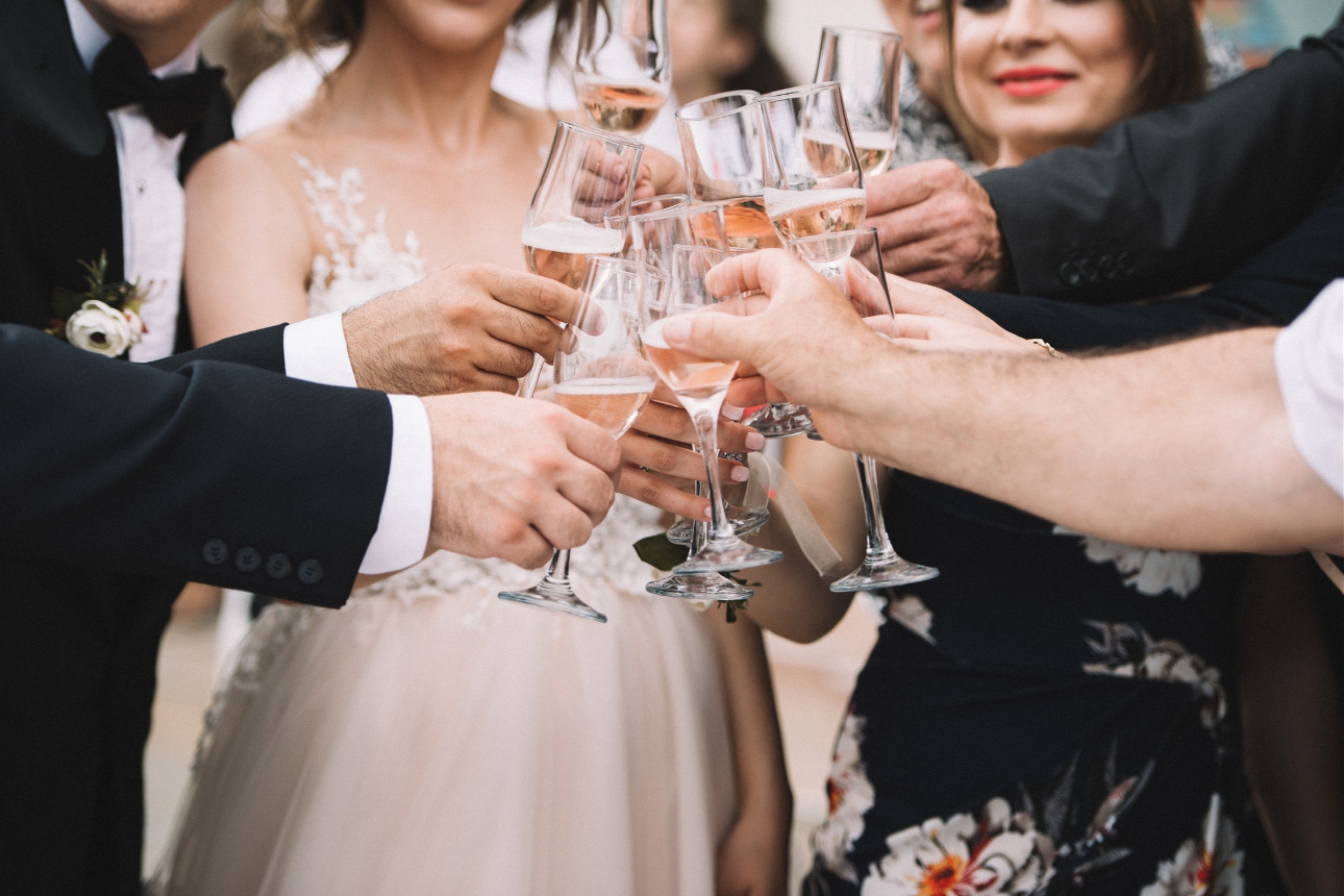 bride and groom having a toast with wedding guests