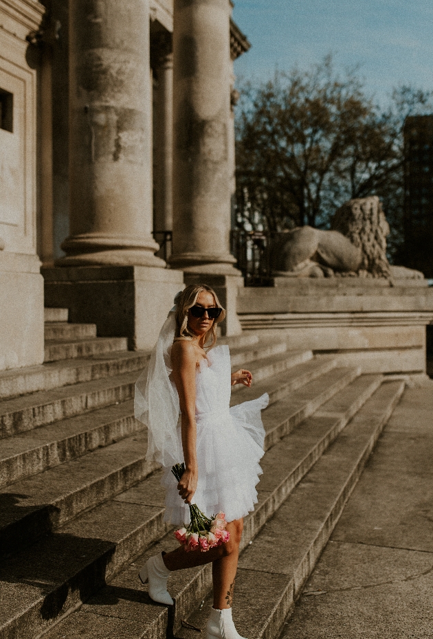 bride looking at camera with sunglasses on 